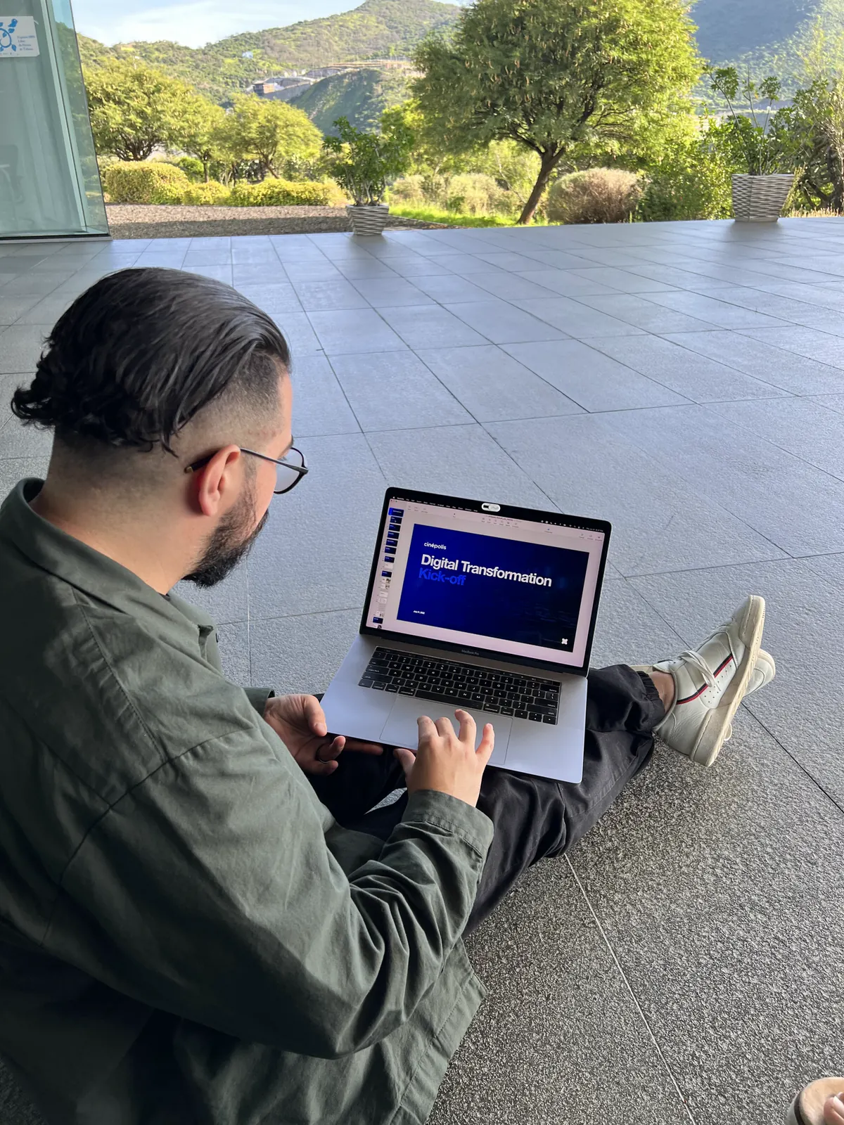 Ricardo at the Cinépolis offices during discovery, the digital transformation deck open on his laptop
